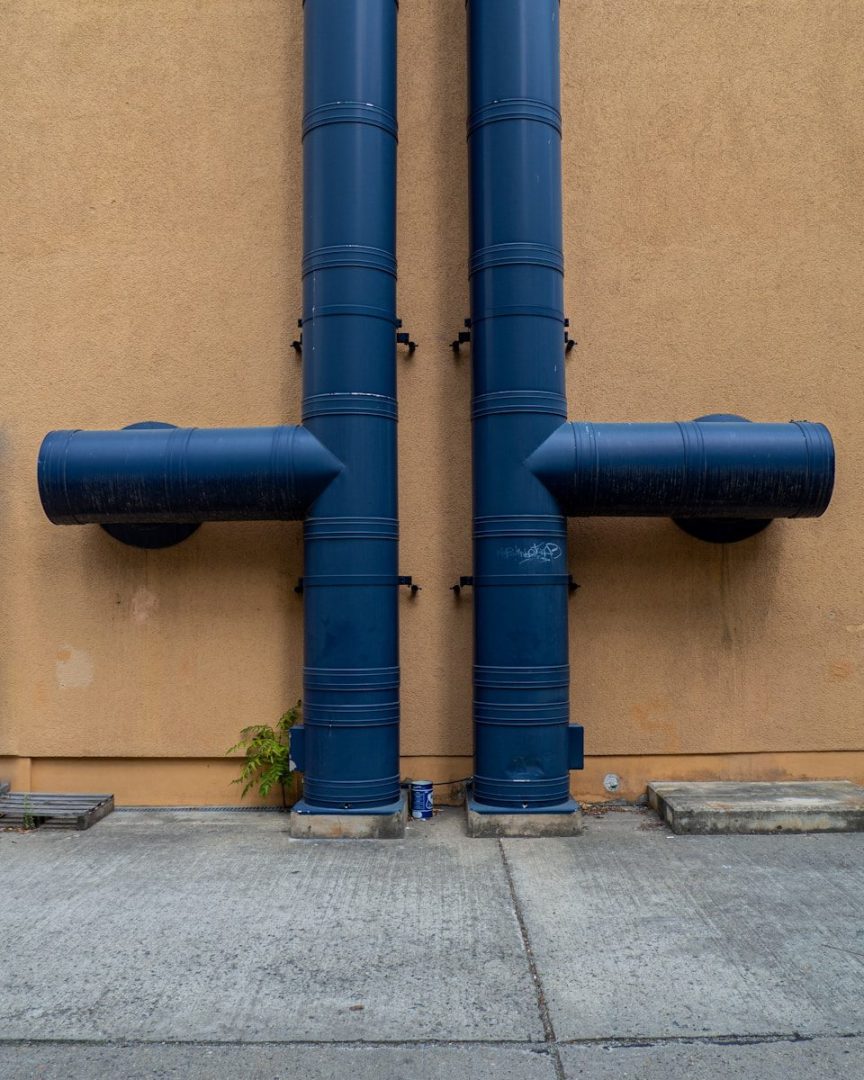 blue rolled textile on brown concrete wall